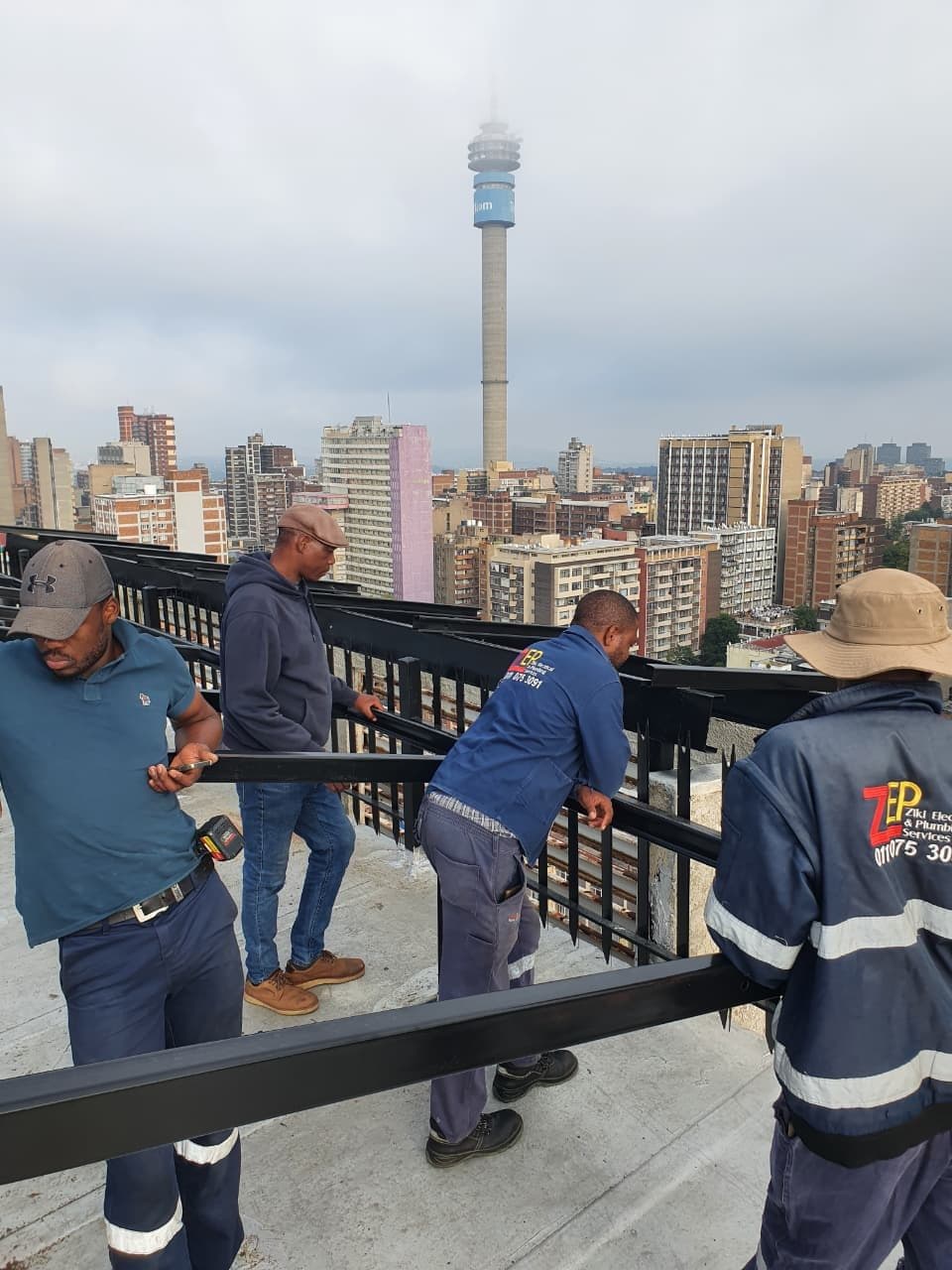 ZEPS team on a Johannesburg rooftop with the Hillbrow Tower behind them